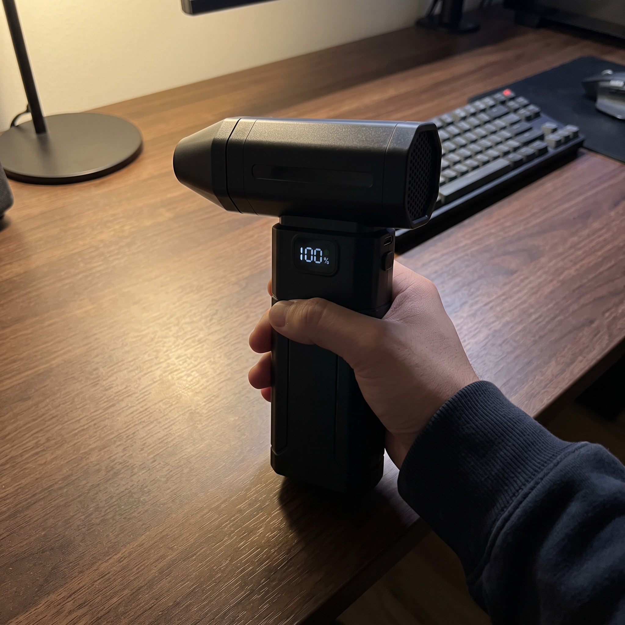 Black ClearJet handheld blower in an everyday dust-cleaning setting 11