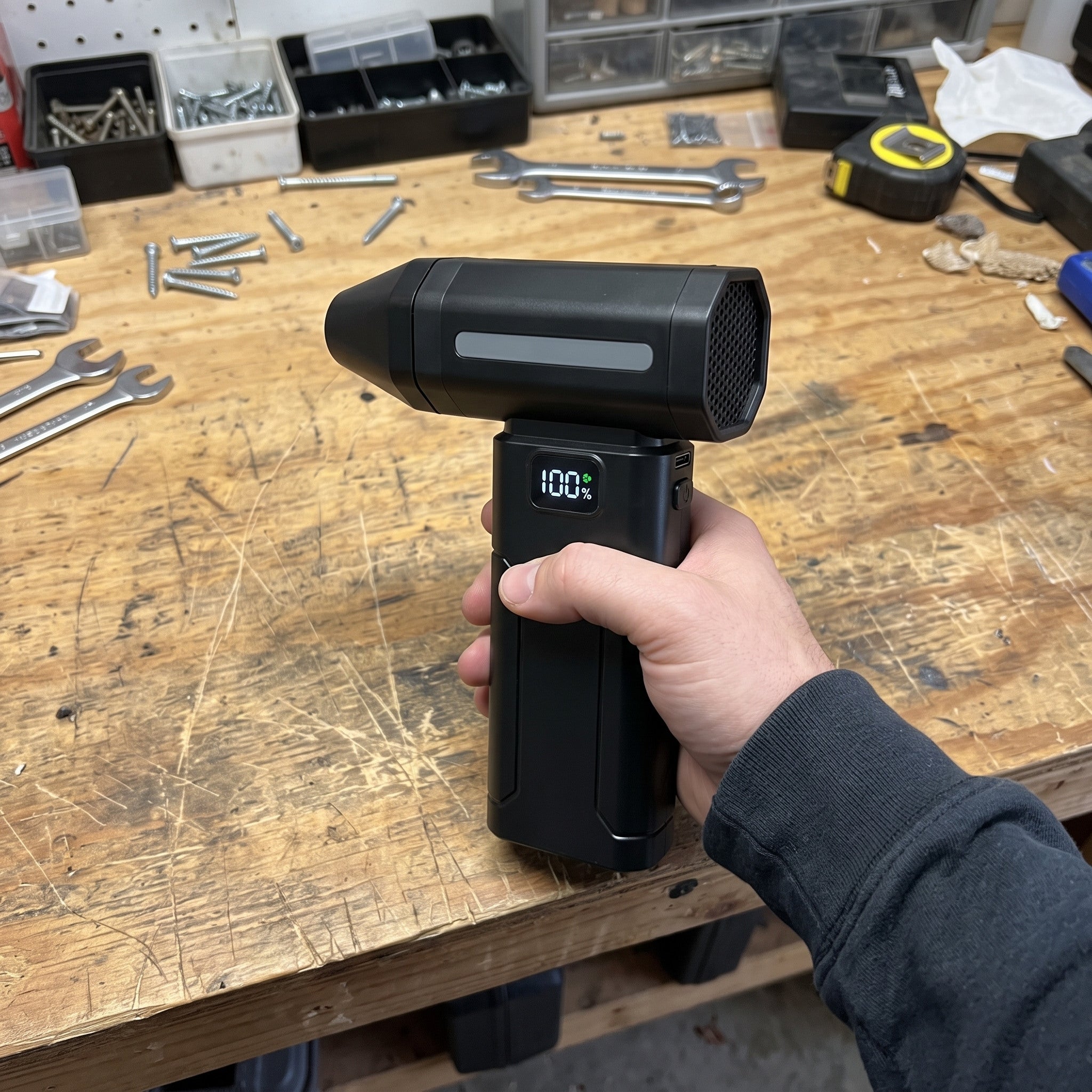 Black ClearJet handheld blower in an everyday dust-cleaning setting 14
